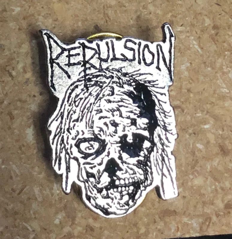 REPULSION - SKULL METAL BADGE